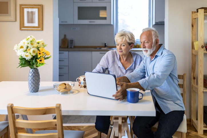 A couple researching the benefits of maxing out their Roth IRA.