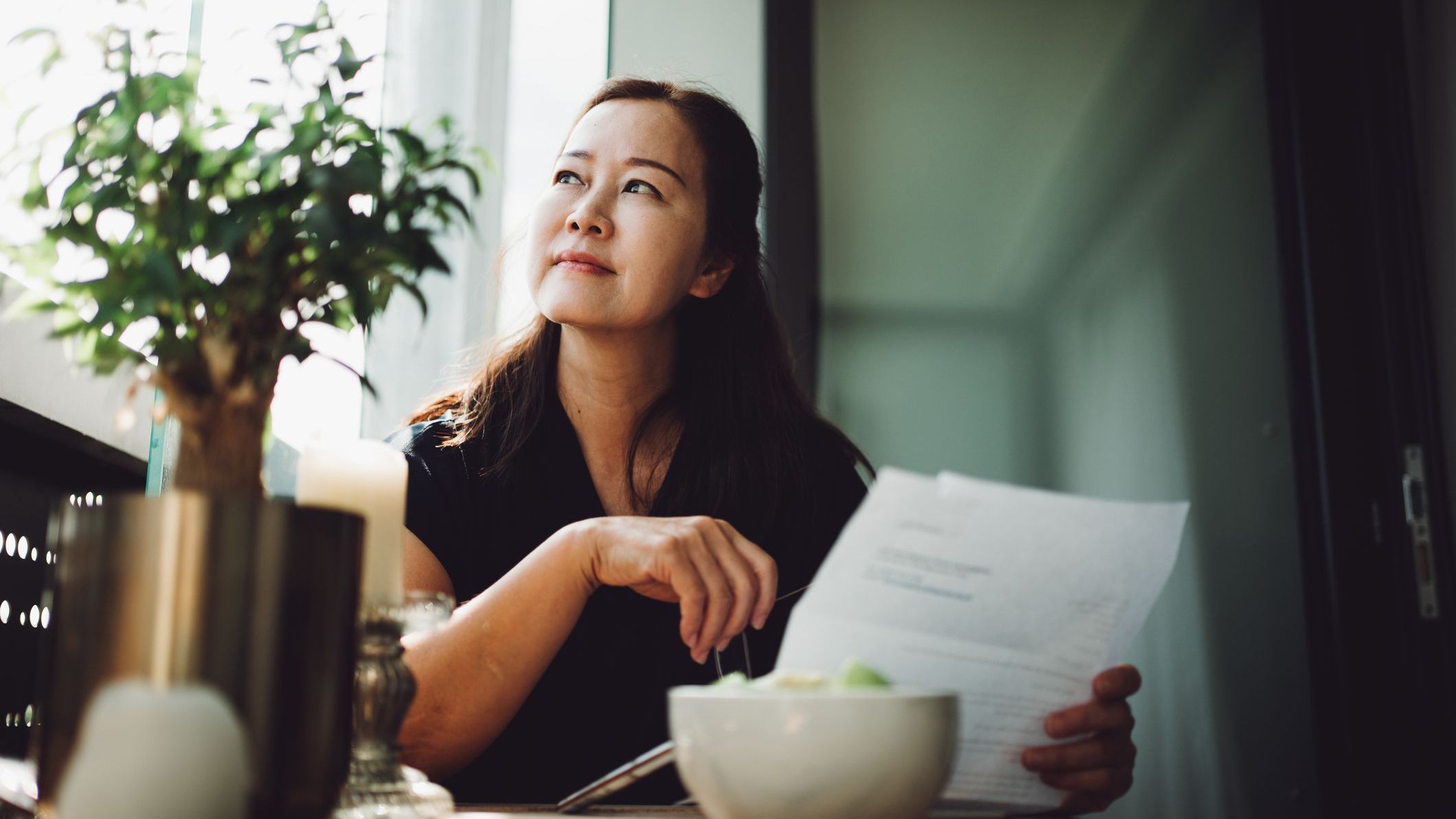 A woman reviews documents from her father's retirement plan following his death.