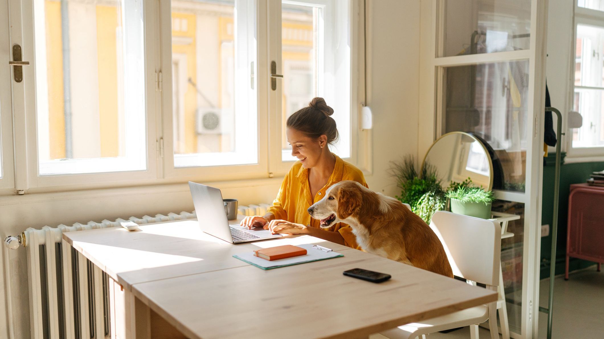 A woman who's semi-retired and works part-time as a consultant takes a virtual call from her inside her apartment.