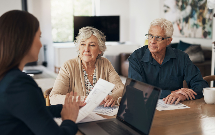 A couple discussing how fixed annuities are taxed with their financial advisor. 